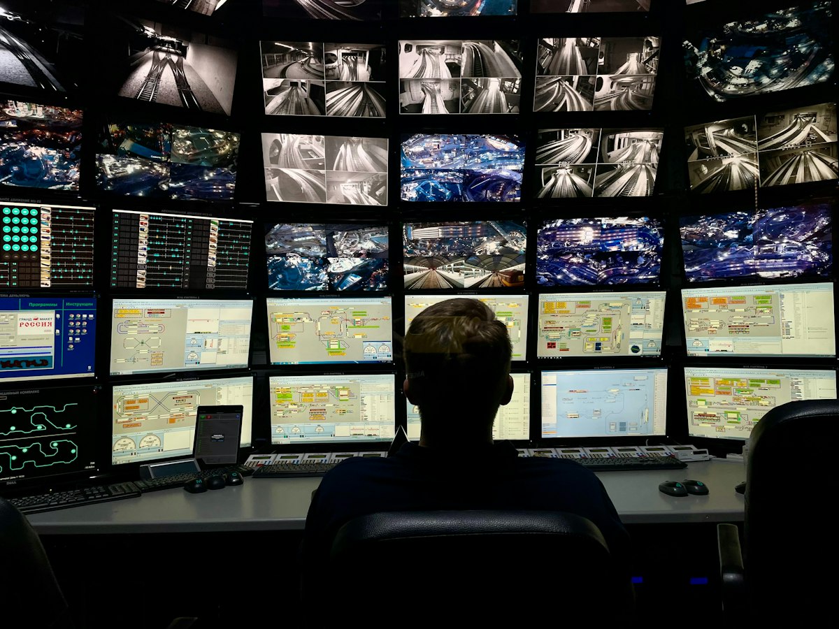 Operator watching several CCTV monitors